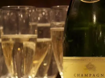 a bottle of champagne sitting next to some glasses at The Black Bull Inn in Balsham