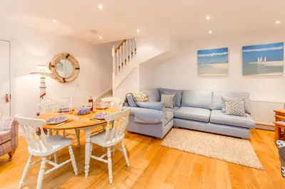 a living room with a table and a couch at The Lobster Pot in Aldeburgh