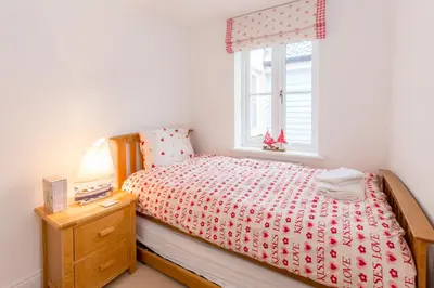 a bedroom with a bed and a window at The Lobster Pot in Aldeburgh