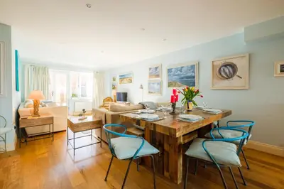 a living room with a wooden table and chairs at Shell Cottage in Aldeburgh