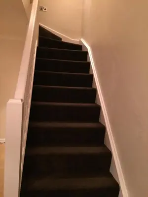 a set of stairs with black treads in a house at Waltham Abbey Private Property in Waltham Abbey