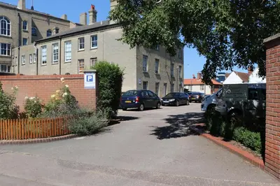 a street with cars parked on the side of a building at On the Quay in Harwich