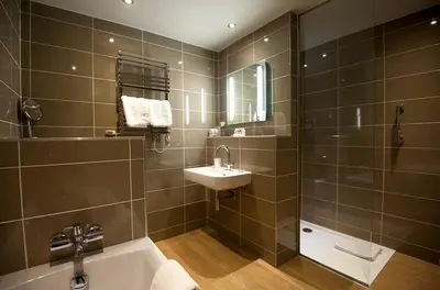 a bathroom with a tub and a sink and a shower at Crown and Castle in Orford