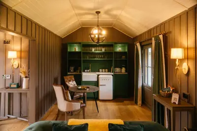 a kitchen with green cabinets and a table in a room at Retreat East in Ipswich