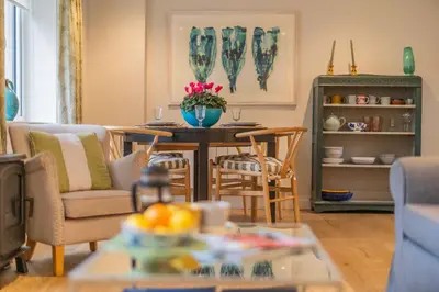 a living room with a table and chairs at Marsh View in Aldeburgh