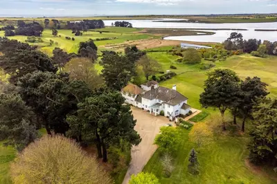 an aerial view of a large white house with trees at Marsh View in Aldeburgh