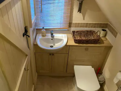 a small bathroom with a sink and a toilet at The Apple Loft in Westleton