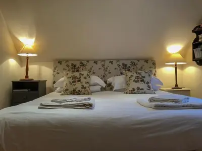 a bedroom with a bed with towels on it at The Apple Loft in Westleton