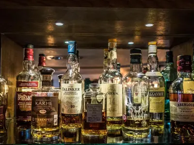 a bunch of bottles of whiskey on a shelf at The Royal Standard in Ely