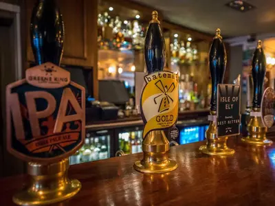 a bar with three bottles of alcohol on a counter at The Royal Standard in Ely