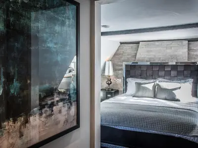 a bedroom with a bed and a large window at The Royal Standard in Ely