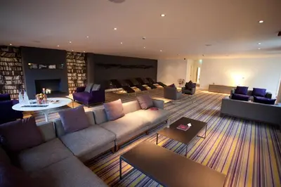 a living room with a couch and chairs and a fireplace at Lifehouse Spa And Hotel in Frinton-on-Sea
