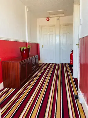 a room with a hallway with a striped carpet at The Grosvenor in Clacton-on-Sea