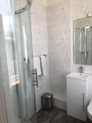 a bathroom with a shower and a sink at The Grosvenor in Clacton-on-Sea