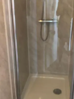 a shower with a glass door in a bathroom at The Grosvenor in Clacton-on-Sea