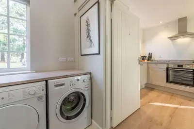 a laundry room with a washer and dryer at Marsh Lodge in Aldeburgh