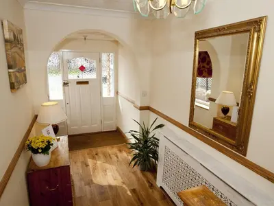 a hallway with a mirror and a stair case at Rosa's Bed and Breakfast in Cambridge