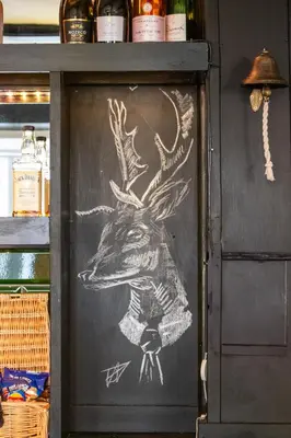 a door with a drawing of a deer on it at The Scole Hotel in Scole
