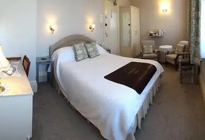 a bedroom with a large white bed in a room at The Chudleigh in Clacton-on-Sea