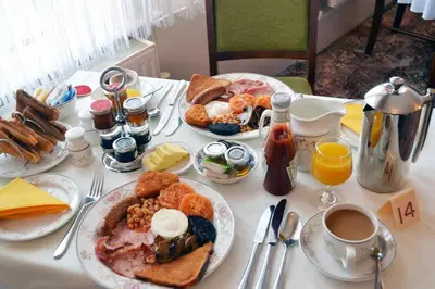 a table topped with plates of breakfast foods and coffee at The Chudleigh in Clacton-on-Sea