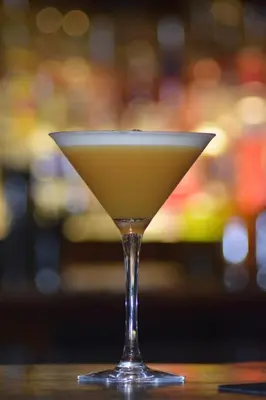 a martini glass sitting on top of a table at The Bull Inn in Mildenhall