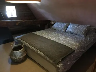 a bedroom with a bed with a pillow and a window at Watt Cottage in Ipswich