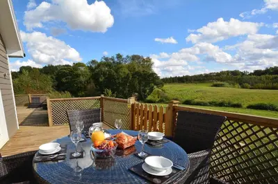 a table with a bowl of food on a patio at Brook Lodge in Colchester