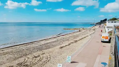 a beach with a bus parked on the side of it at The Langtry Hotel in Clacton-on-Sea