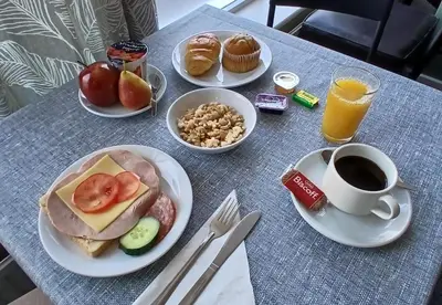 a table with plates of breakfast foods and a cup of coffee at The Langtry Hotel in Clacton-on-Sea