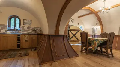 a kitchen with an archway and a table with chairs at West Stow Pods in Bury St Edmunds in West Stow