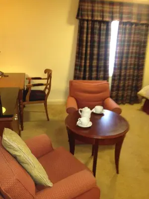 a living room with a couch and a coffee table at The Olde Windmill Inn in Great Cressingham