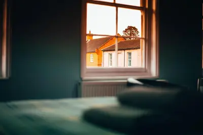 a window with a view of a house at The Kings Head in New Buckenham