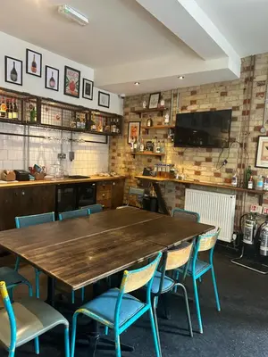 a dining room with a wooden table and chairs at The Waterman in Cambridge