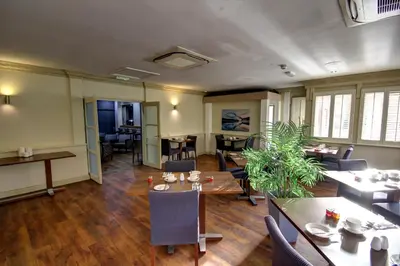 a room with tables and chairs and a dining room at The Rochford Hotel in Southend-on-Sea