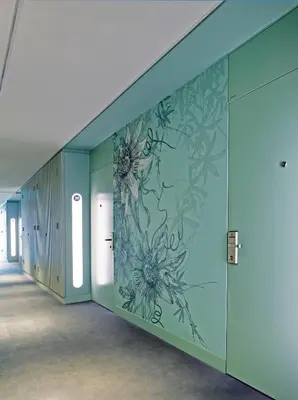 a wall mural of flowers on a wall in a hallway at Hinxton Hall Hotel and Conference Centre in Hinxton