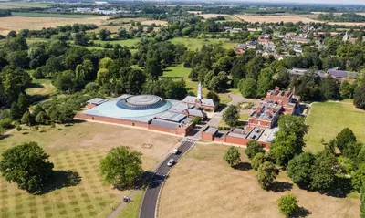 an aerial view of an old building with a church at Hinxton Hall Hotel and Conference Centre in Hinxton