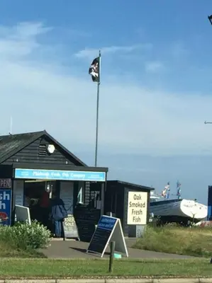 a flag on top of a building with a sign at Wentworth Hotel in Aldeburgh
