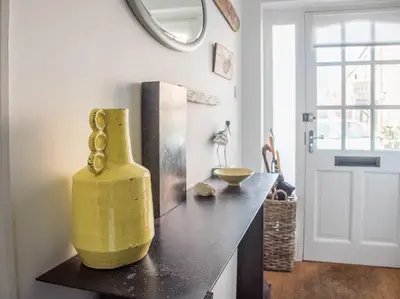 a yellow vase sitting on a counter in a kitchen at Honeybee Cottage, Orford in Orford