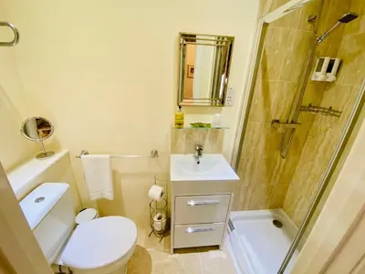 a bathroom with a toilet and a shower and a sink at Pier View Self Catering Luxury Apartments in Southend-on-Sea