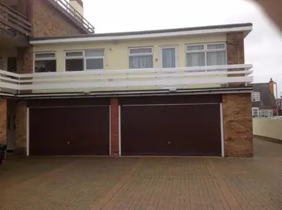 a house with two garage doors in front of it at 9 Gunfleet court in Clacton-on-Sea