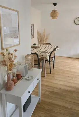 a living room with a table and a dining room at Welcome Home in Royston