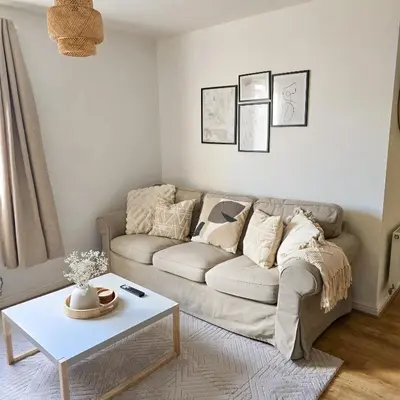 a living room with a couch and a table at Welcome Home in Royston