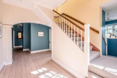 a staircase in a home with blue walls at Hillcrest, Aldeburgh in Aldeburgh