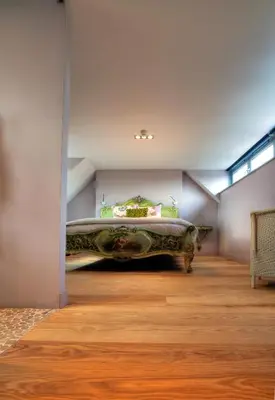a bedroom with a large bed in the corner of a room at Strattons in Swaffham