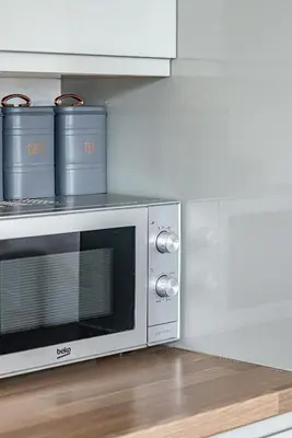 a microwave oven sitting on top of a kitchen counter at Greyfriars in Clacton-on-Sea