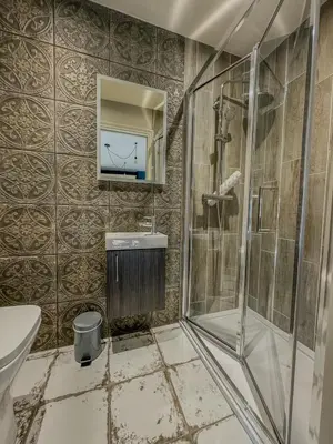 a bathroom with a shower and a sink at The White Horse Hotel in Leiston