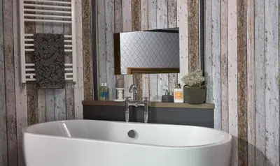 a bathroom with a white tub and a mirror at Mersea Island by Away Resorts in Colchester