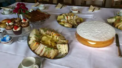 a table with many different types of food on it at The Griffin Hotel in Attleborough