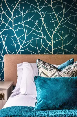 a bedroom with a bed with a blue and white wall at The Cricketers Clavering in Clavering