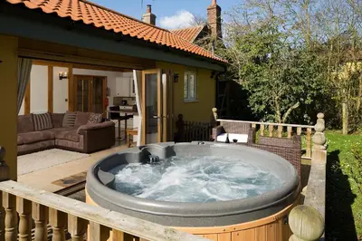 a hot tub in the yard of a house at Owl's Hoot in Thorndon